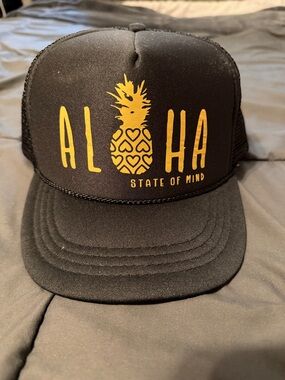 Black Trucker Hat with Yellow "ALOHA" Pineapple Graphic
